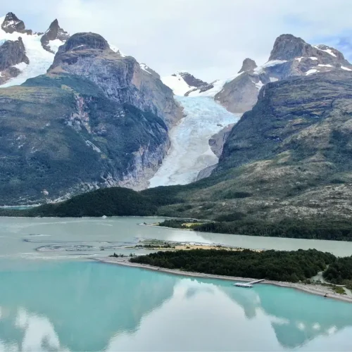 Natural panoramic view connecting Monte Balmaceda Lodge with the grandeur of Serrano Glacier and Patagonian mountains.